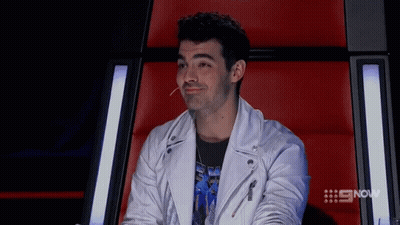 Young Man In Plaid Shirt And Suspenders Laughing GIF