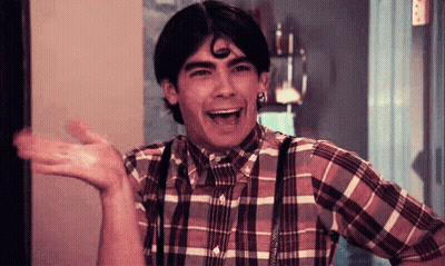 Young Man In Plaid Shirt And Suspenders Laughing GIF