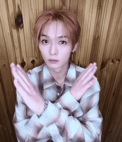 Young Man In Plaid Shirt Making Cross With Hands GIF