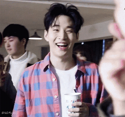 Young Man In Plaid Shirt Smiling Holding Coffee GIF