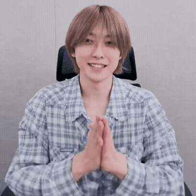 Young Man In Plaid Shirt Smiling With Hands Folded GIF