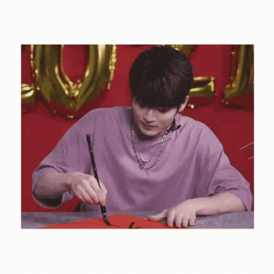 Young Man In Purple Shirt Holding Brush GIF