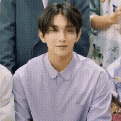 Young Man In Purple Shirt Sitting With Group GIF