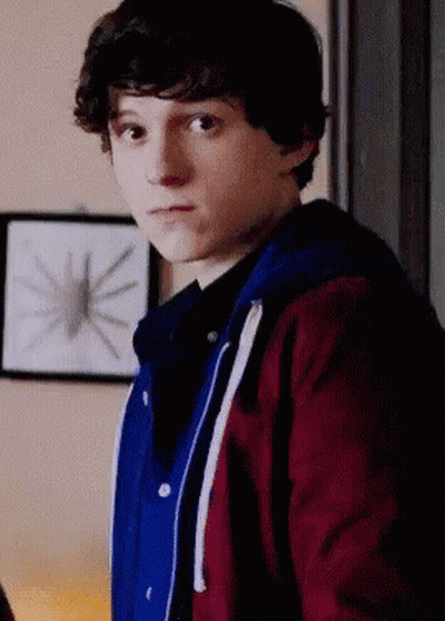 Young Man In Red And Blue Jacket In Front Of Spider Picture GIF