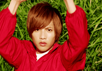 Young Man In Red Jacket In Grass Field GIF