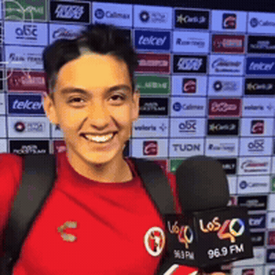 Young Man In Red Shirt Holding Microphone Smiling GIF