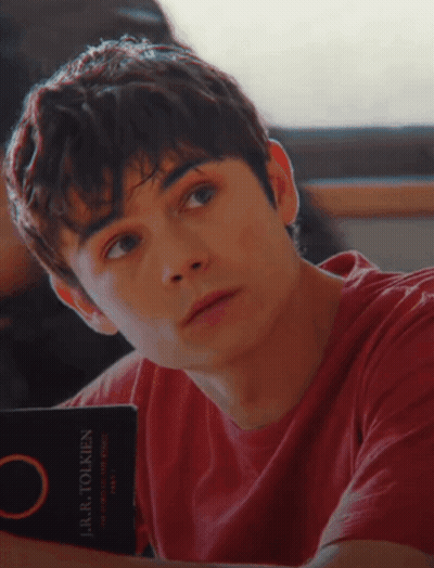 Young Man In Red Shirt Reading Laura Tolkien GIF