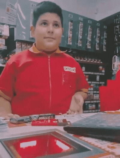Young Man In Red Shirt Sitting At Counter GIF