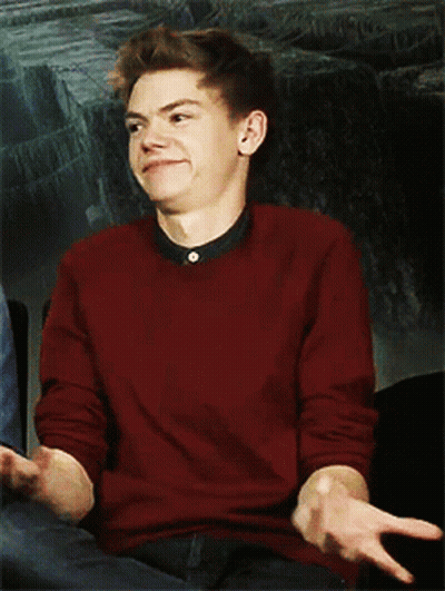 Young Man In Red Sweater Sitting In Chair GIF