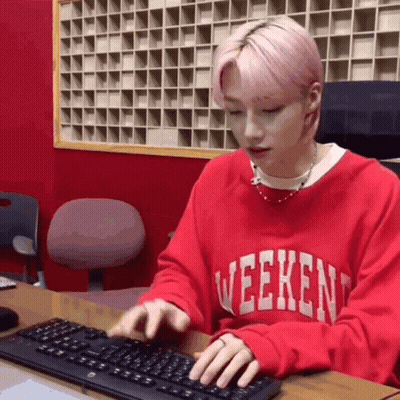 Young Man In Red Sweater Typing On Keyboard GIF