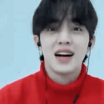 Young Man In Red Sweater With Earphones Smiling GIF