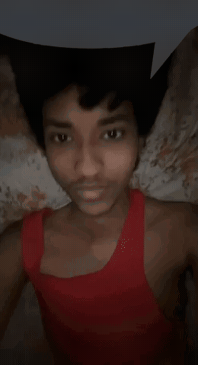 Young Man In Red Tank Top Lying On Bed GIF