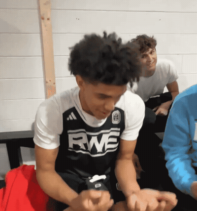 Young Man In RWE Jersey Sitting In Locker Room GIF