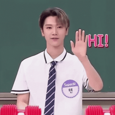 Young Man In School Uniform Waving At Greenboard GIF