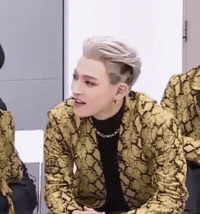 Young Man In Snakeskin Jacket Sitting In Chair GIF