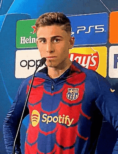 Young Man in Spotify Jersey at Microphone