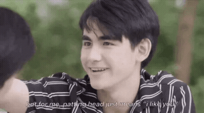 Young Man In Striped Shirt Smiling Talking To Another Man GIF