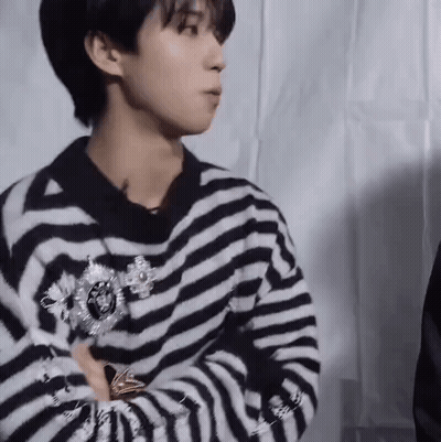 Young Man In Striped Sweater With Brooch GIF