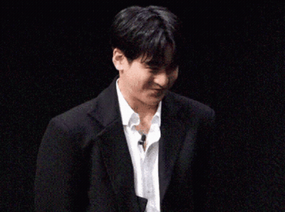 Young Man In Suit And Tie Holding Paper GIF