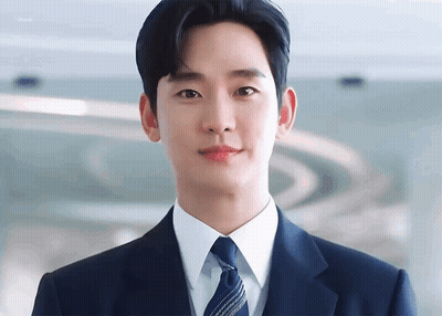Young Man In Suit And Tie Looking At Camera GIF