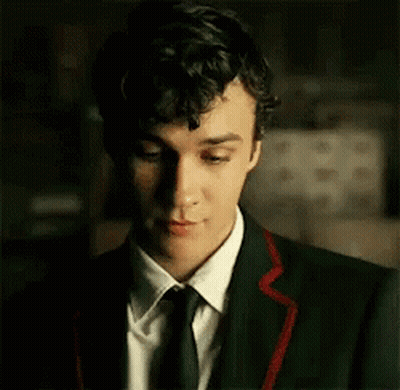 Young Man In Suit And Tie Looking Down GIF