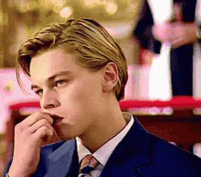 Young Man In Suit And Tie Looking Down GIF