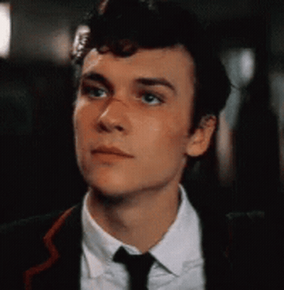 Young Man In Suit And Tie Looking Up GIF