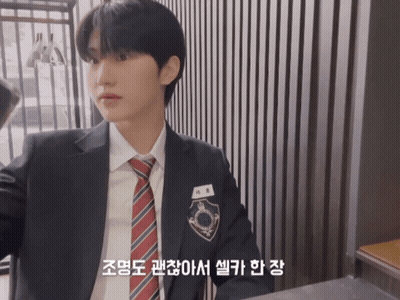 Young Man In Suit And Tie With Korean Writing GIF