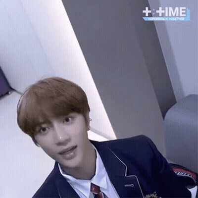 Young Man In Suit And Tie With + Time Sign GIF