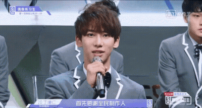 Young Man In Suit Holding Microphone GIF