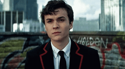 Young Man In Suit In Front Of Holden Wall GIF