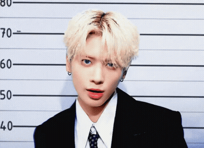 Young Man In Suit In Police Lineup GIF
