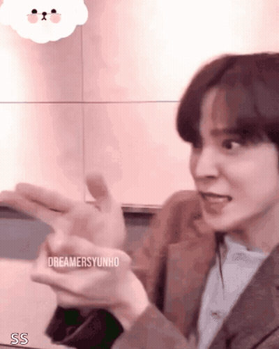 Young Man In Suit Making Funny Face With Hands Out GIF