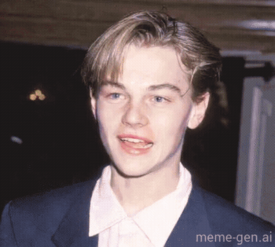 Young Man In Suit Smiling For Camera GIF