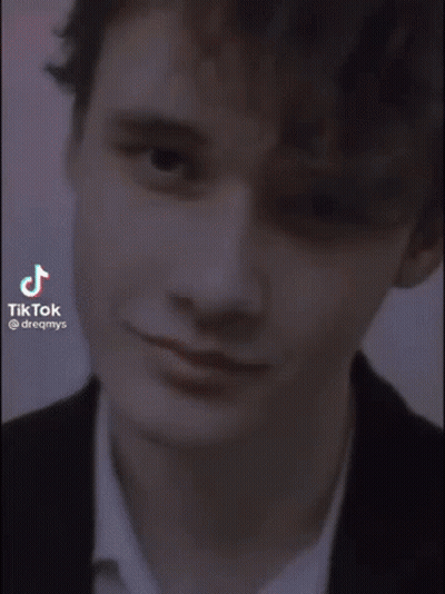 Young Man In Suit Smiling In Elevator GIF