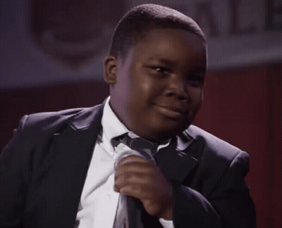 Young Man In Suit Smiling With Microphone GIF