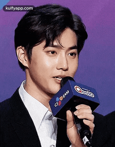 Young Man In Suit Talking Into Microphone GIF