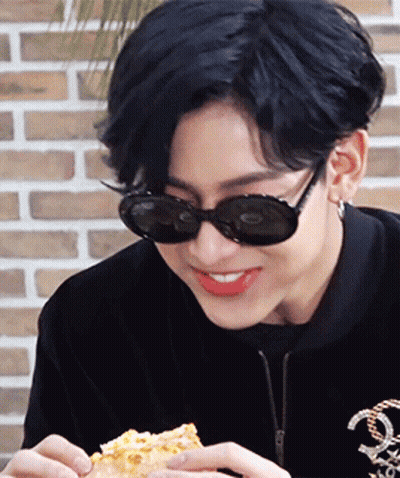 Young Man In Sunglasses And Black Jacket Eating Pizza GIF
