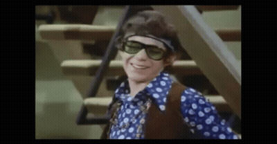 Young Man In Sunglasses And Headband On Stairs GIF