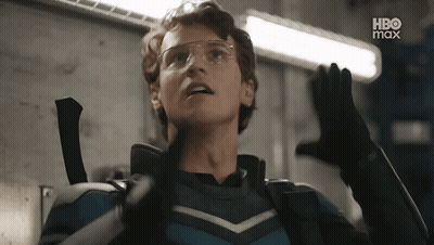 Young Man In Superhero Costume With Glasses And Gloves GIF