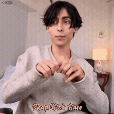 Young Man In Sweater Making Heart With Hands Chapstick Time GIF