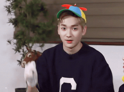 Young Man In Sweater With Letter C Holding Stuffed Animal GIF