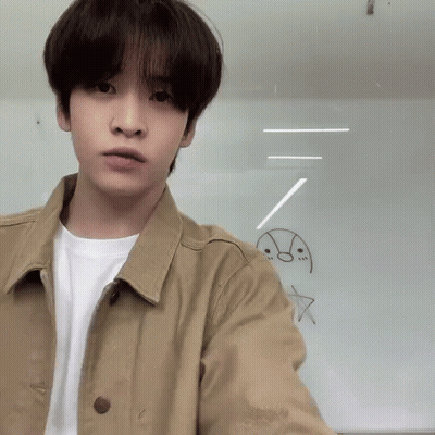 Young Man In Tan Jacket And White Shirt GIF