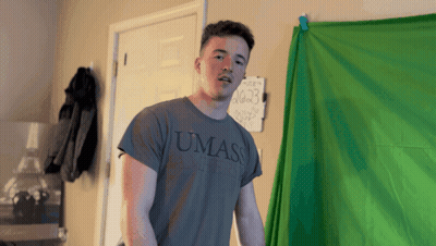 Young Man In UMass Shirt In Front Of Green Screen GIF