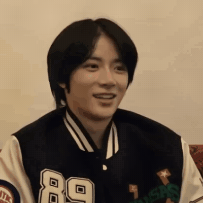 Young Man In Varsity Jacket Smiling GIF