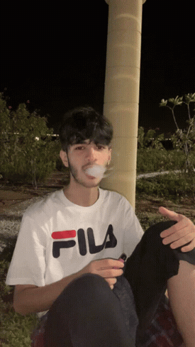 Young Man In White Fila T-Shirt Smoking Cigarette GIF
