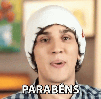 Young Man In White Hat And Plaid Shirt Says Parabéns GIF