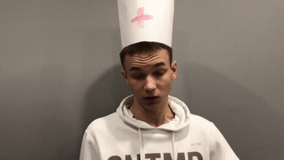 Young Man In White Hoodie And Hat With Pink Cross GIF