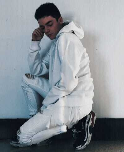 Young Man In White Hoodie And Jeans Squatting GIF
