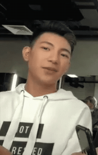 Young Man In White Hoodie Holding Cell Phone GIF